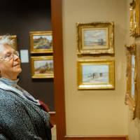 Guest admiring paintings at Friends of Alten 2018
